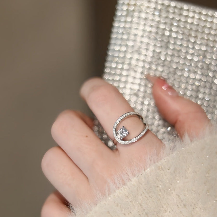 Geometric Open‑Band Ring Four‑Prong Center Diamond With Paved Side Stones