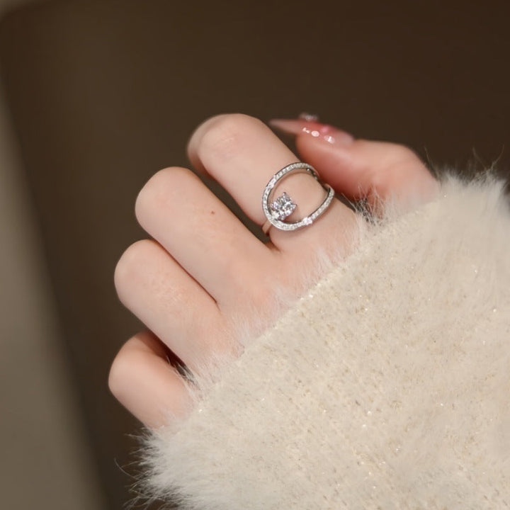 Geometric Open‑Band Ring Four‑Prong Center Diamond With Paved Side Stones