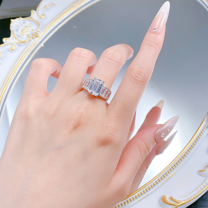 Emerald Cut Diamond Three-Stone Ring with Side Baguette Accents